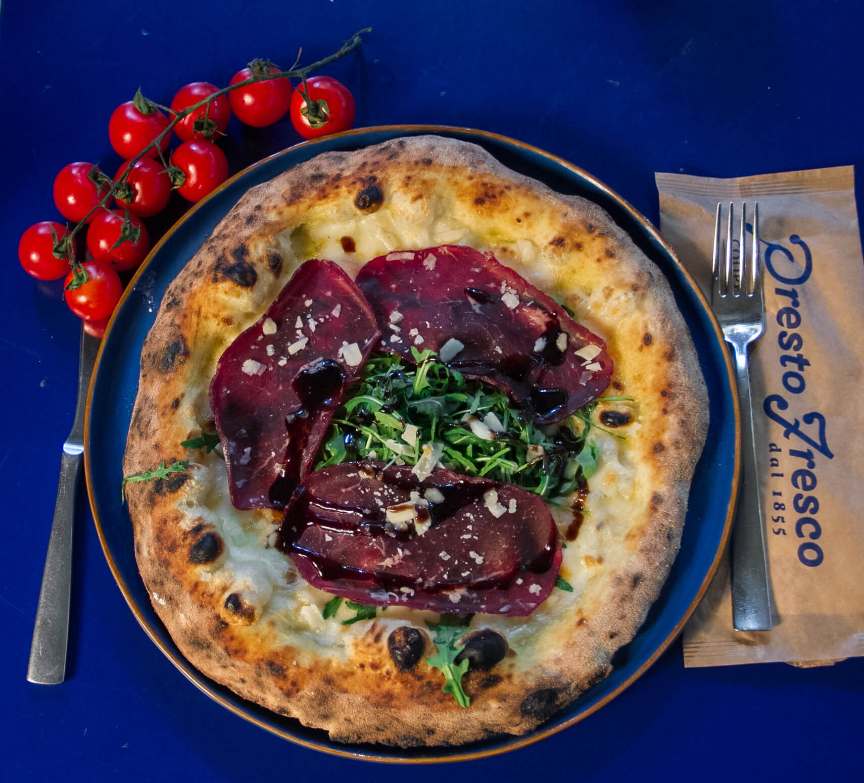 Wood-fired pizza served at Presto Fresco
